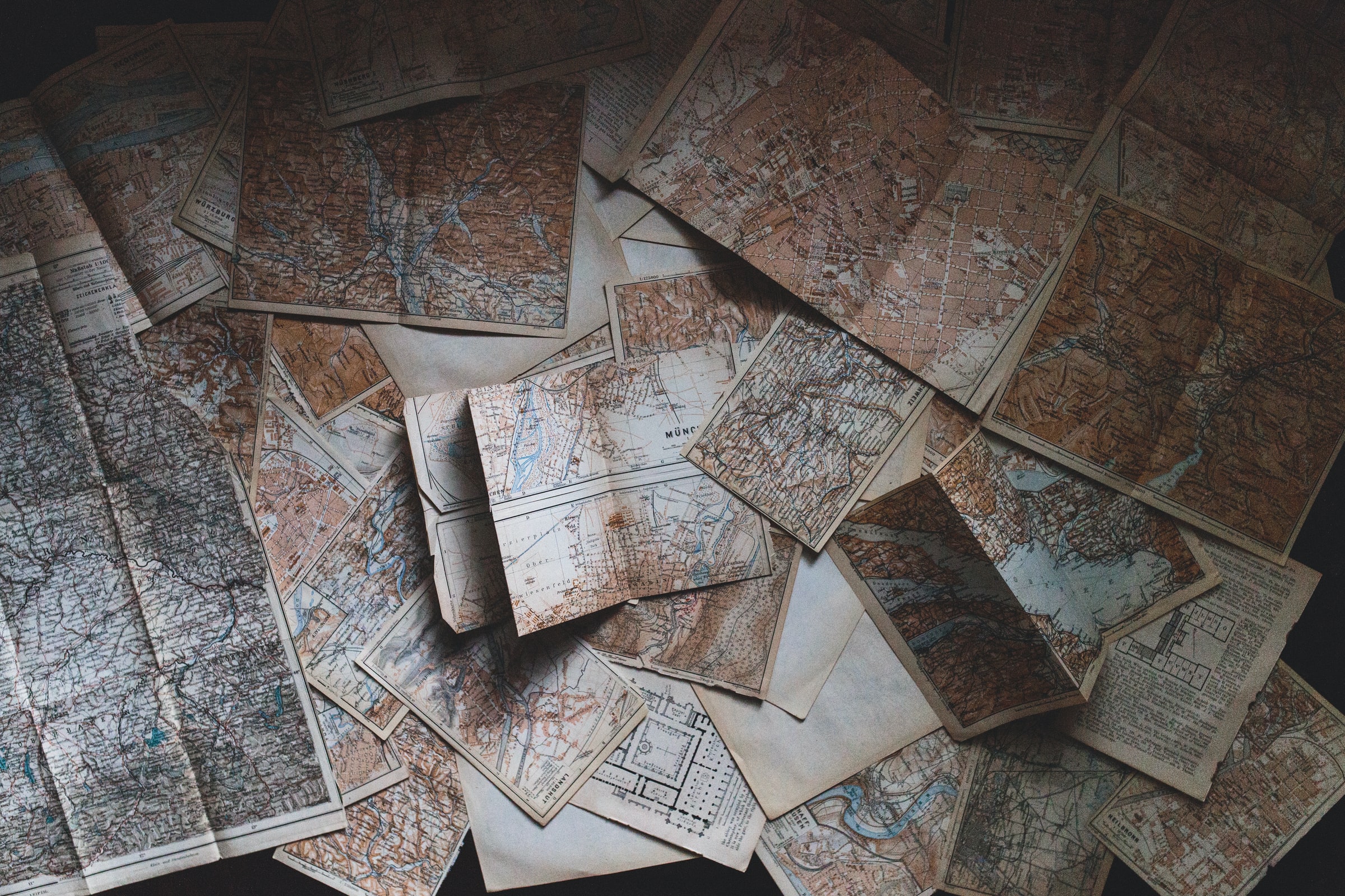 Decorative, image of multiple maps laying open and unfolded