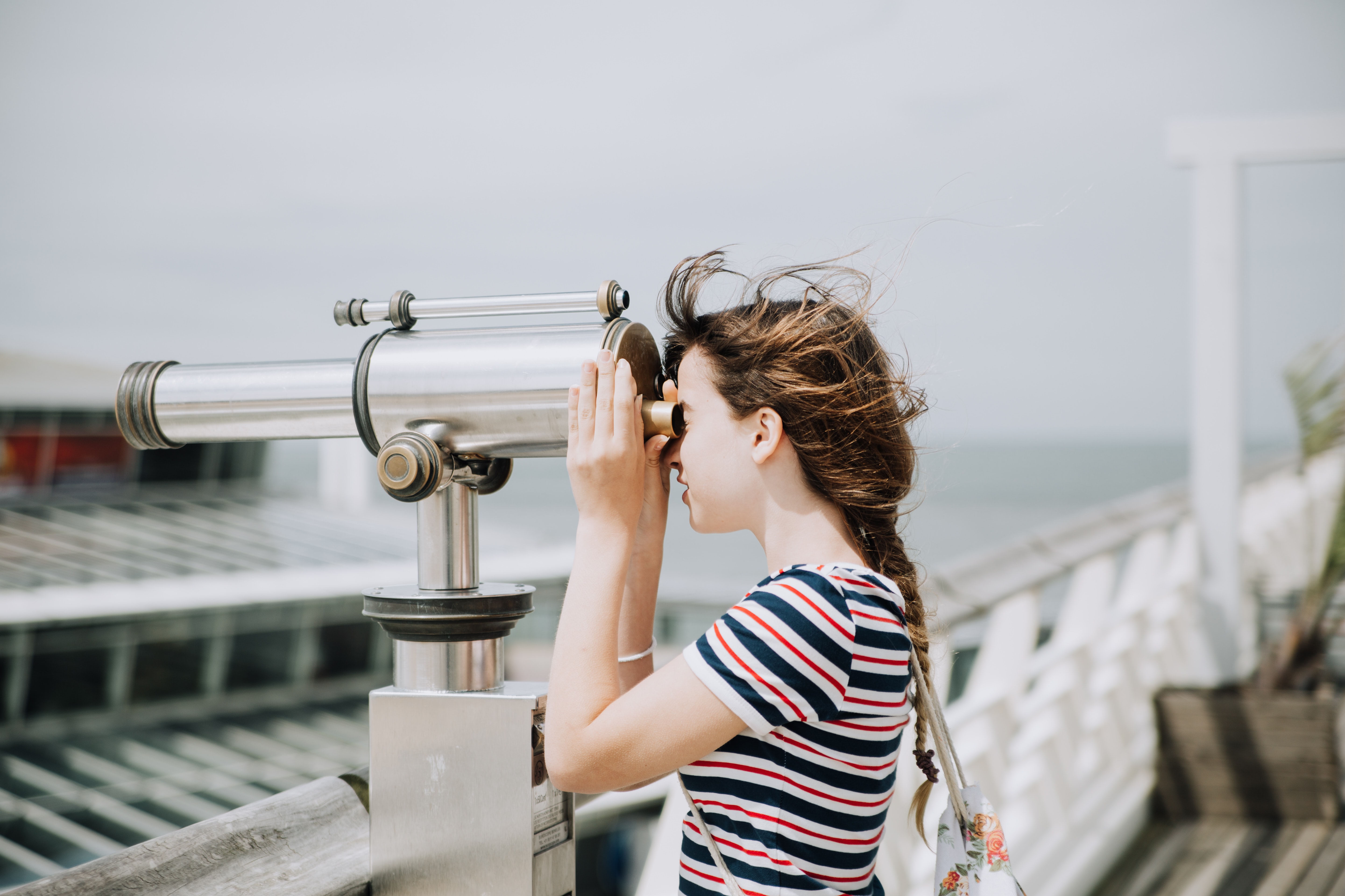 Decorative, person looking out of large binoculars