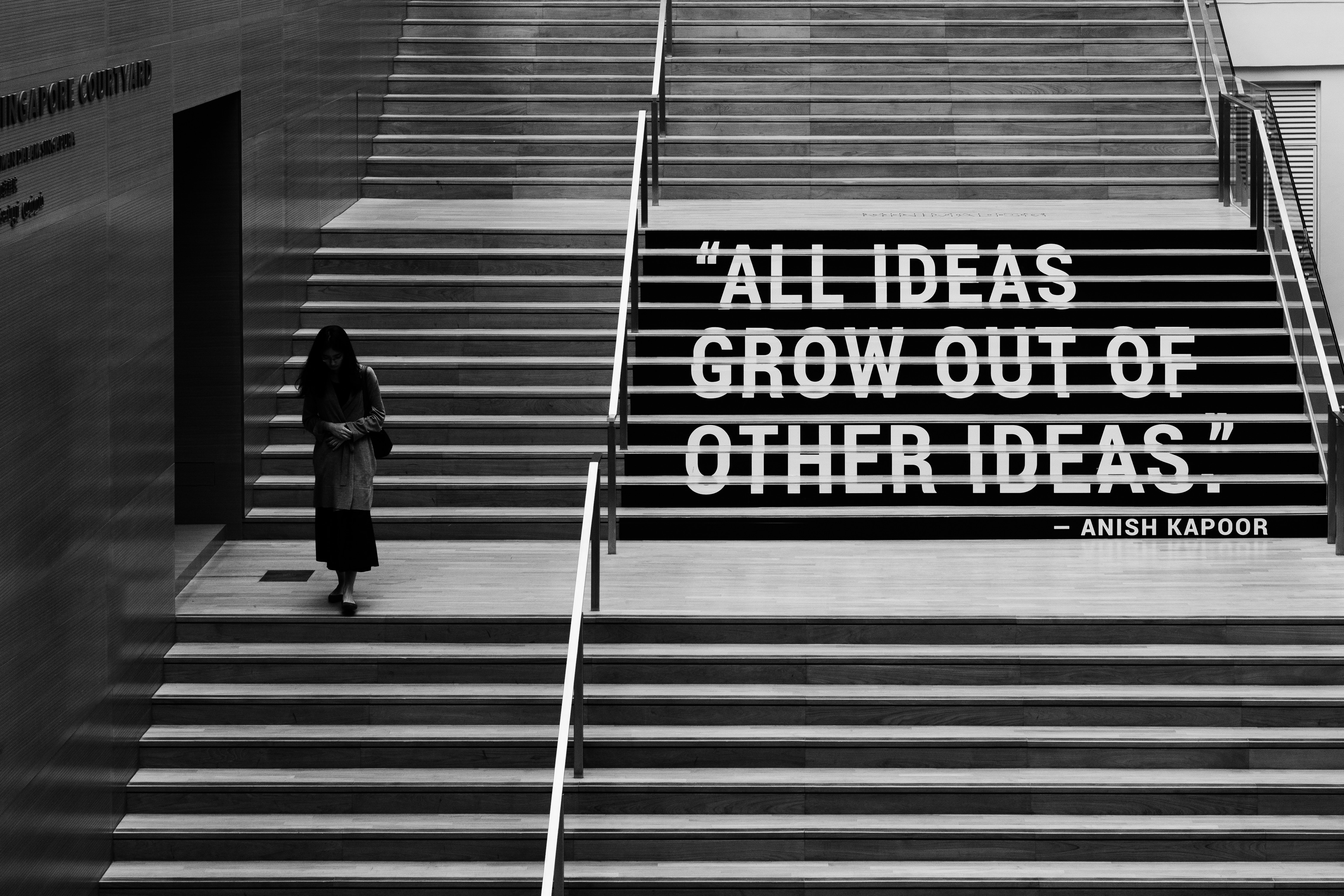 Decorative, "all ideas grow out of other ideas" quotation on staircase